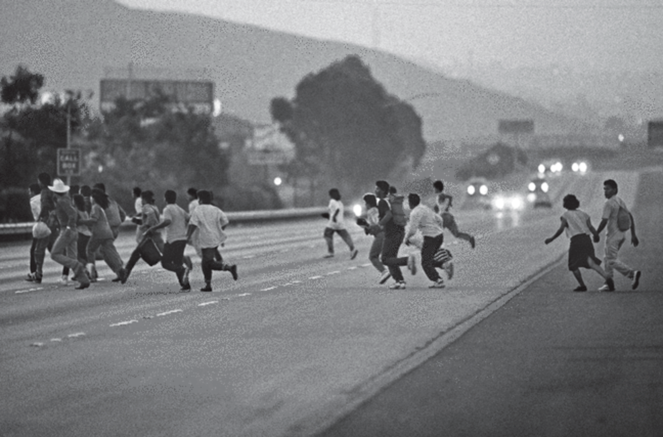 people running across a highway
