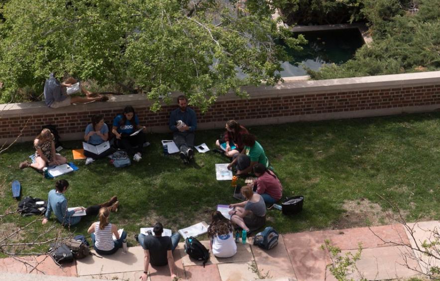 students sitting in a circle outside
