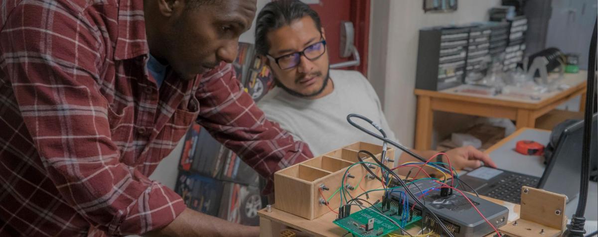 Men connecting up robotics and wires